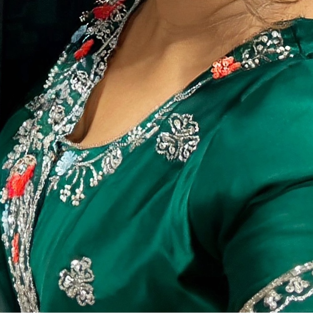 Gorgeous bottle green saree with silver zari and orange work